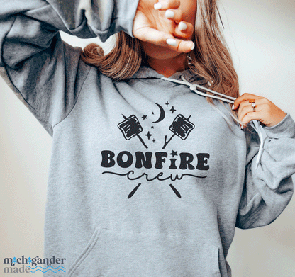 A fleece hoodie in heather grey with Michigander Made Bonfire design