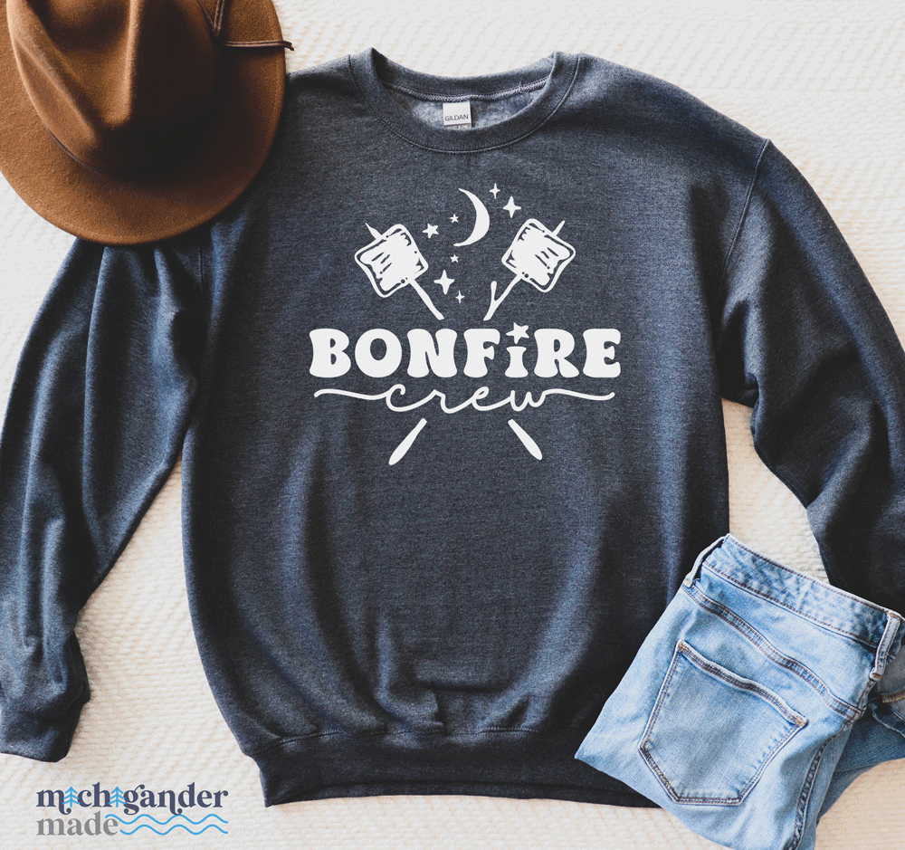 A crewneck sweatshirt in dark heather with Michigander Made Bonfire design