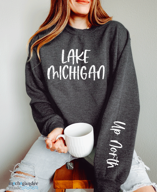 A crewneck sweatshirt in dark heather grey with Michigander Made Lake Michigan Up North design
