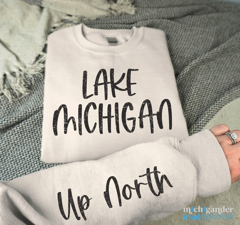 A crewneck sweatshirt in sand with Michigander Made Lake Michigan Up North design