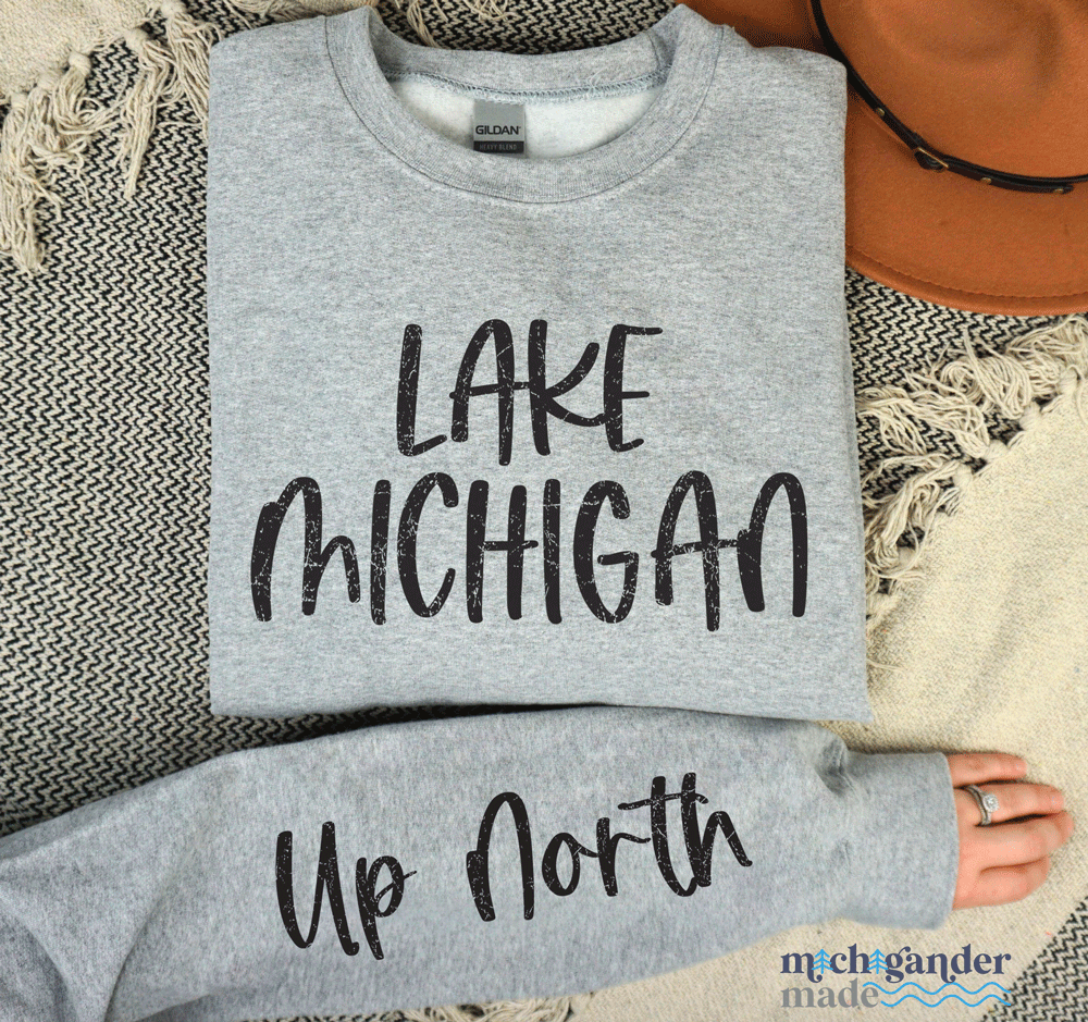 A crewneck sweatshirt in sport grey with Michigander Made Lake Michigan Up North design