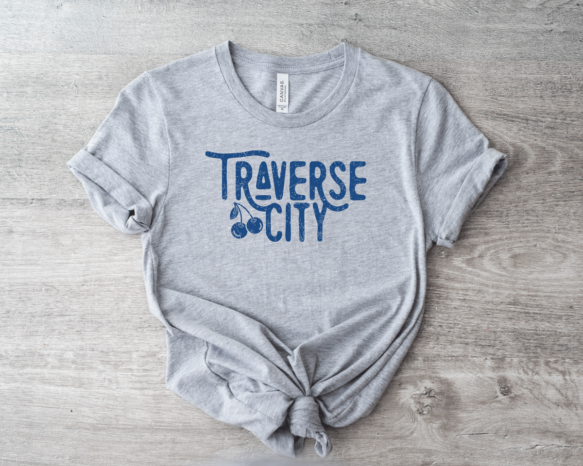 Traverse City t-shirt with a cherry in the logo. Traverse city one of a kind design tee. Traverse City tee.